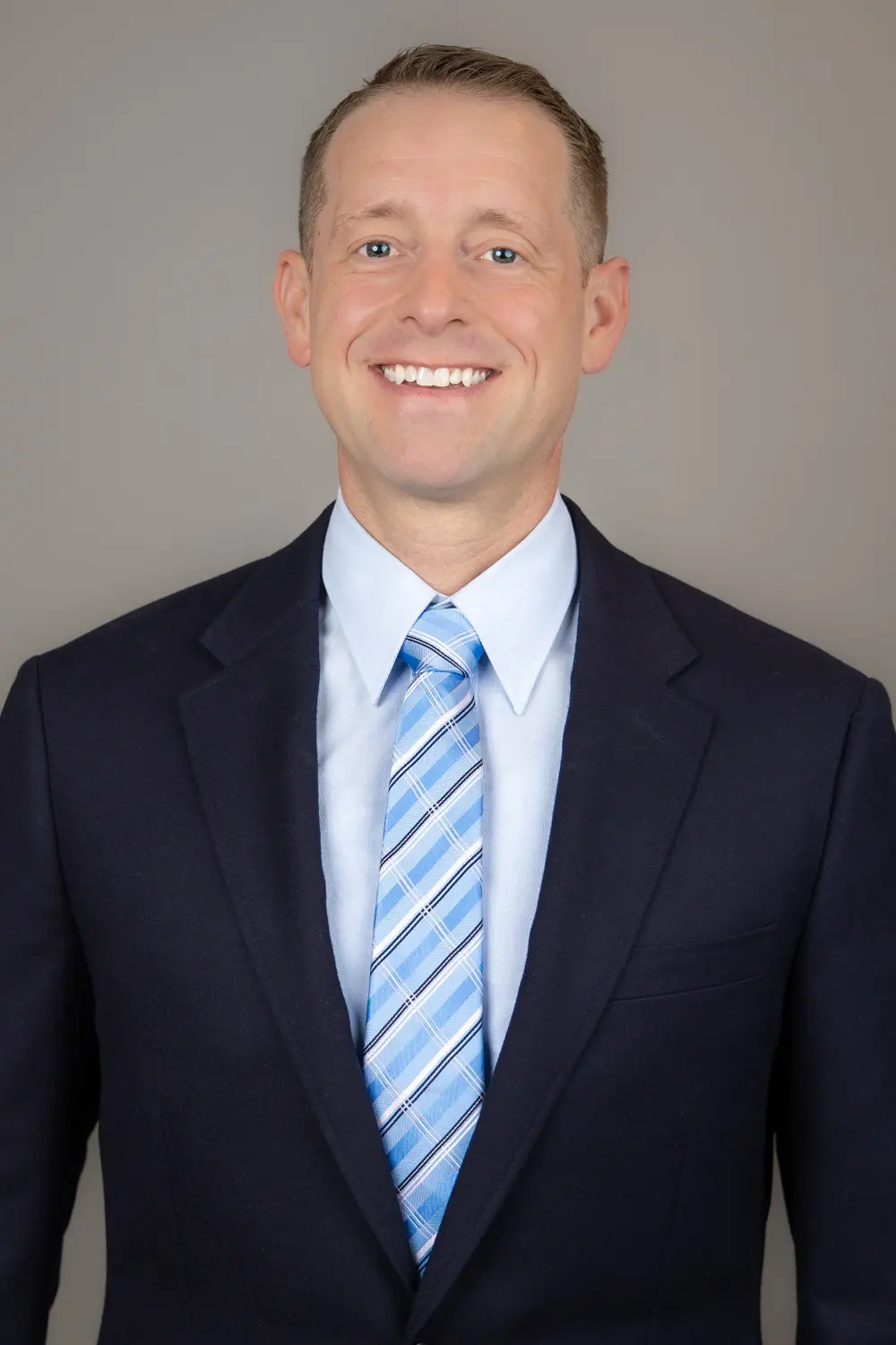 Ryan Schaffer wearing a dark suit and blue tie.